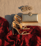 clutch, sandalias y accesorios elegantes que combinen con tela fondo rojo y estampado de hojas rojo oscuro